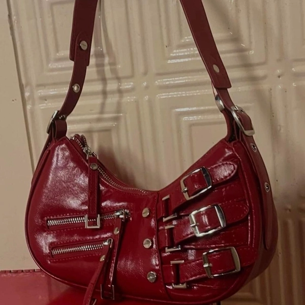 Red wine leather shoulder bag with zipper and buckle...
