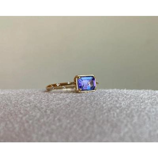 14k Tanzanite Ring with a Diamond Dotted Band