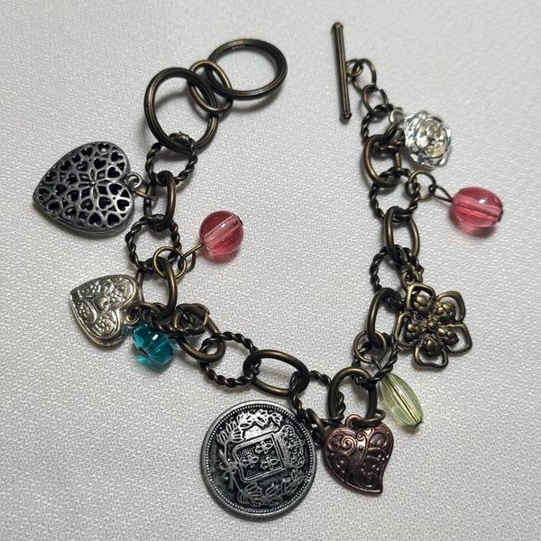 Bronze tone multi  charm bracelet.

7-8 inch length...