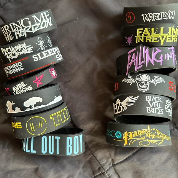 Set of black band bracelets featuring logos and...