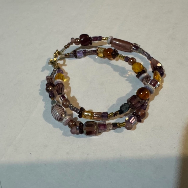 Brown and purple glass beaded bracelet with a touch...