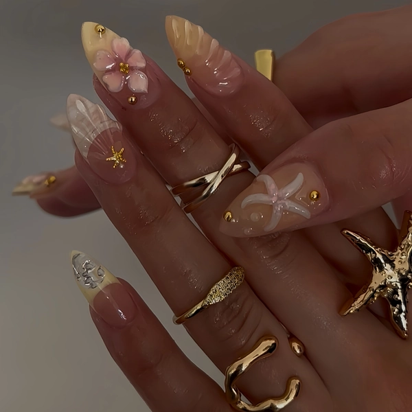 24pcs Medium Long Almond Shell-Carved Fake Nail Set, Featuring 3D Starfish, Flowers, and Metallic Pearl Ocean Elements, Clear and Dreamy Style, Perfect for Summer Vacations, Beach Photos, and Travel Looks, Creating an Ethereal Nail Design.