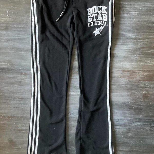 Rockstar black sweatpants with white stripes on the...