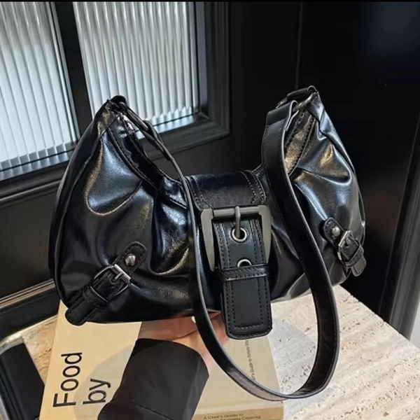 Black leather shoulder bag with silver hardware...