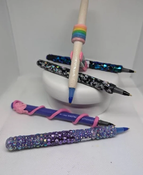Decorated Bic ballpoint pens Polymer clay, resin rhinestones, chunky glitter, sealed with UV resin Black/blue ink Buy more-get a discount.