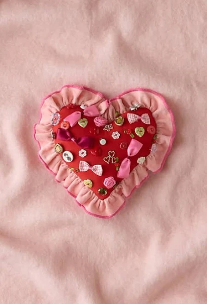 Beaded Heart Ruffle Throw Pillow in Pink at Urban Outfitters