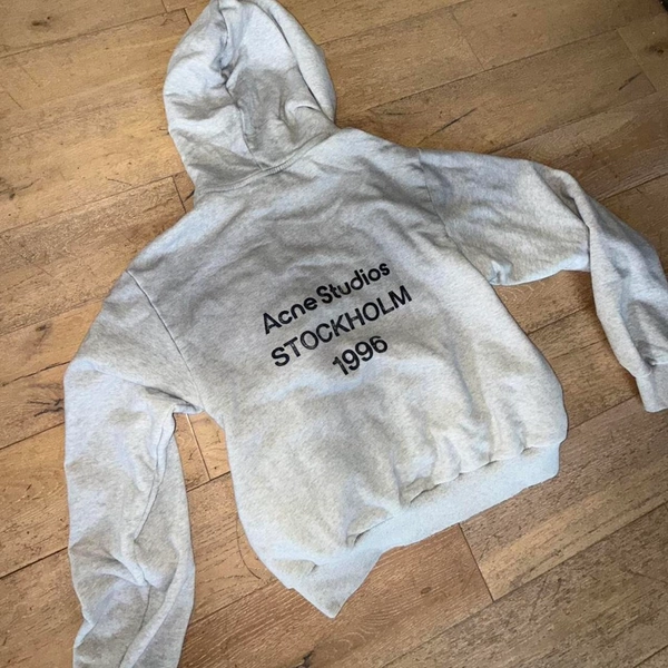 Acne Studios gray hoodie with black text reading...