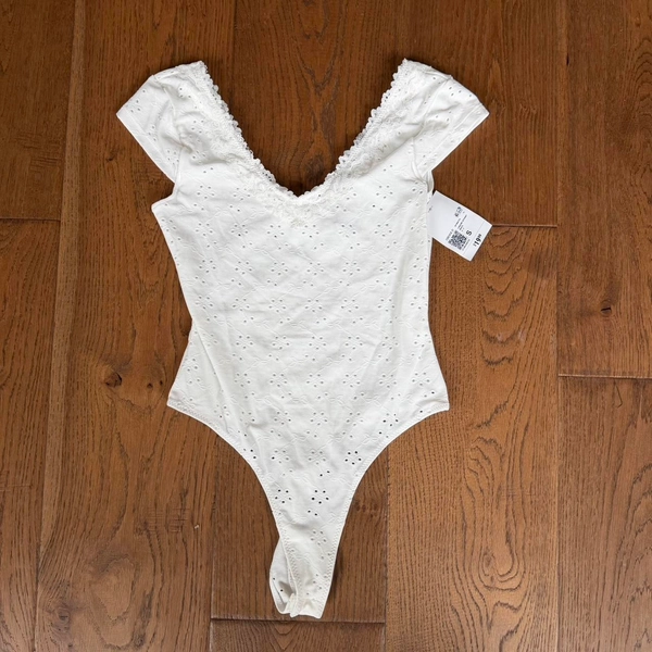 Forever21 
White lace bodysuit with open back and...