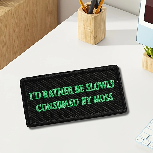 A Patch Featuring The Embroidered Phrase 'I'D Rather Be Slowly Consumed by Moss' for Clothing Decoration