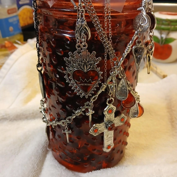 Red and black gothic glass jar with metal chains,...