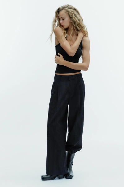 PINSTRIPED TROUSERS WITH DARTS AND POCKET FLAPS