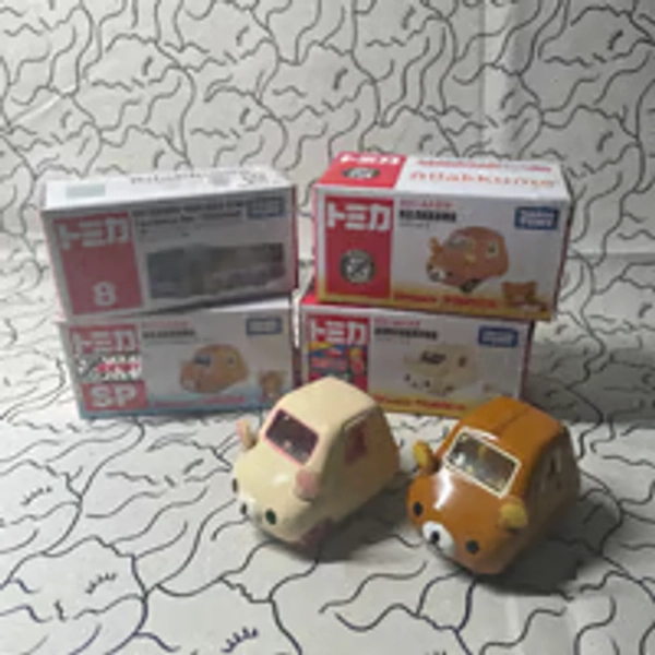 Four rilakkuma tomica toy cars